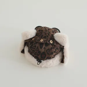 Close-up of leopard print winter trapper hat with goggles and faux fur lining detail