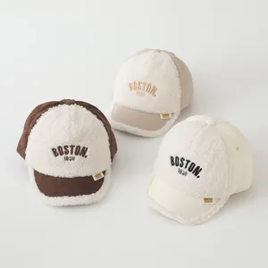 Close-up of three warm winter BOSTON baseball caps in beige, brown, and cream fleece