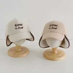 Detail of warm winter earflap baseball caps with GOOD Luck embroidery and plush lining