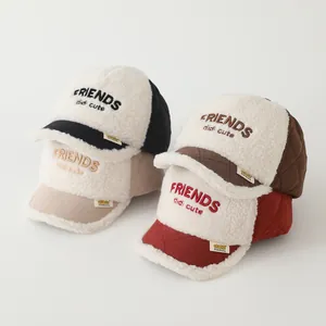 Close-up of four colors of kids' fleece baseball caps with warm quilted fabric and embroidery