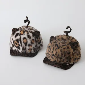 Detailed view of plush leopard print baby baseball caps with cute ears and tail accents