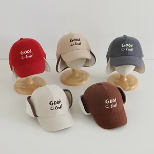 Detailed view of fleece winter baseball hats with ear flaps and Good Luck embroidery