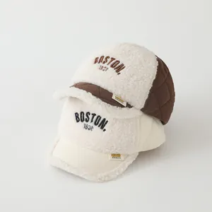 Close-up of baby sherpa baseball caps with BOSTON embroidery and quilted brim details