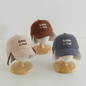 Detailed view of fleece winter earflap hats with GOOD Luck embroidery and warm lining