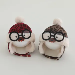 Detail of baby leopard print trapper hats with pom-poms and cartoon bear glasses