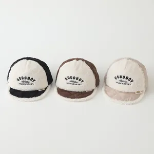 Three children's quilted fleece baseball caps in black, brown and beige with embroidery