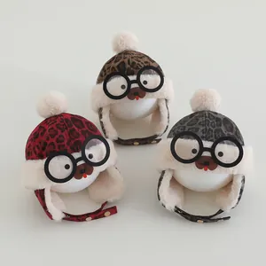 Detailed view of three leopard print baby aviator hats with goggles and pom-poms