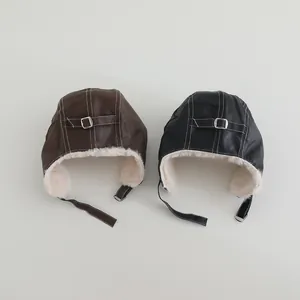 Close-up of winter aviator hats with faux leather exterior and warm sherpa lining details