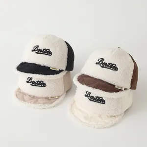 Detail of winter baby baseball hats featuring fleece texture and Boston embroidery