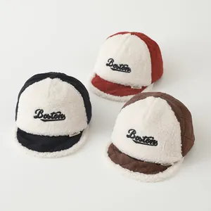 Detail of children's fleece baseball caps in navy, red, and brown with Boston embroidery