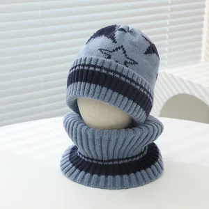 Detail of blue knitted winter hat and neck warmer set with star pattern for kids