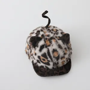 Detail of baby leopard print faux fur hat with plush ears and spiral tail design