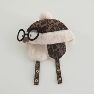 Detail of leopard print baby winter trapper hat with furry pom-pom and glasses decor