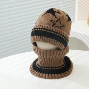 Detailed texture of brown and black knitted winter set with star pattern and ear flaps