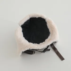 Detail of winter trapper hat showing quilted lining and plush faux fur earflaps