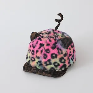 Detail view of colorful leopard print baby plush hat with cute ears and curled tail decoration