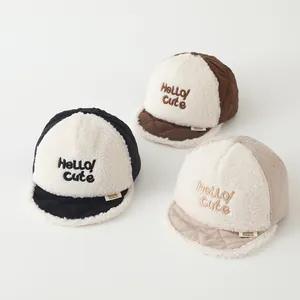 Detailed close-up of quilted velvet baby baseball caps with cozy lamb wool texture