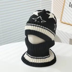 Close-up of knit winter hat and neck warmer set with star pattern for kids