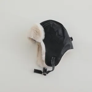 Detail of warm winter trapper hat with star leather patch and soft fleece lining
