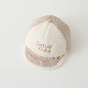 Detailed close-up of baby winter cap featuring Hello Cute embroidery and soft lamb wool trim