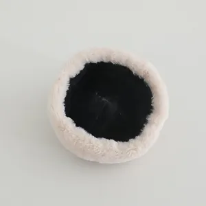 Detailed view of plush Chinese style winter baby hat with soft faux fur and black lining