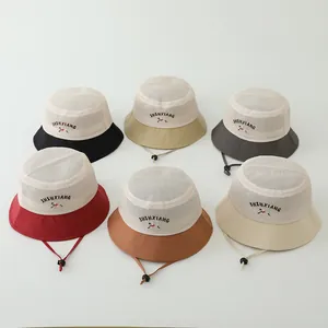 Detail of mesh breathable kids sun hats with puppy embroidery and adjustable chin straps