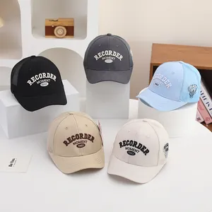 Multi-color mesh baseball caps with detailed embroidery on minimalist display stands