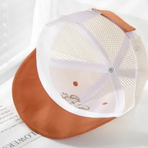 Detail of mesh back and cute bear embroidery on breathable orange kids baseball cap