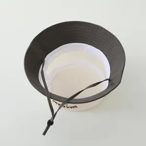 Detail of breathable white mesh crown and grey brim with adjustable drawstring