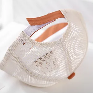 Detail of breathable beige mesh baseball cap with orange adjustable velcro strap
