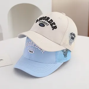 Breathable mesh baseball caps in cream and blue with vintage 1983 embroidery details