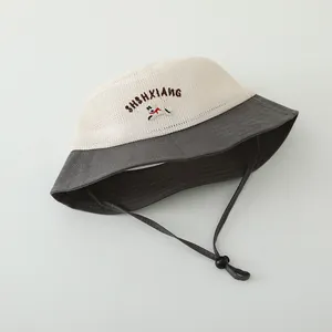 Detail of breathable mesh fabric and dog embroidery on the summer sun protection hat