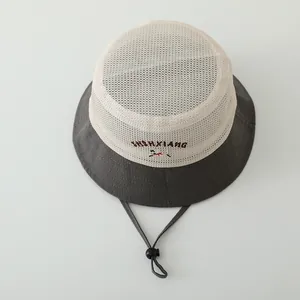 Detail of dual-tone kids bucket hat with breathable mesh top and adjustable chin strap