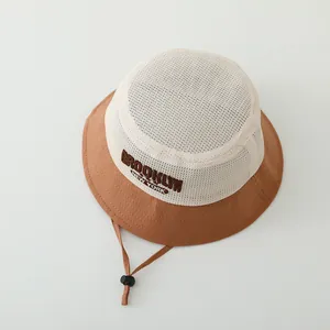 Detail of breathable mesh crown and embroidered Brooklyn lettering on kids sun hat