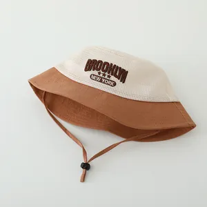 Detailed macro view of the mesh top and embroidered Brooklyn logo on this baby sun hat