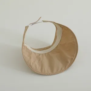 Close-up of khaki children's sun visor with breathable quick-dry fabric and wide brim.