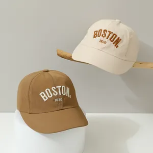 Detail of BOSTON embroidery on quick-dry kids baseball caps with laser ventilation holes