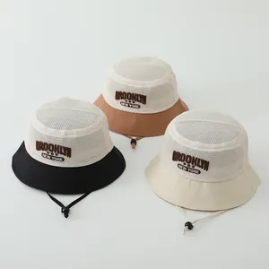 Close-up of three mesh sun hats with Brooklyn New York embroidery and adjustable straps