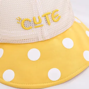 Detail of baby sun hat showing breathable mesh material and yellow CUTE embroidery