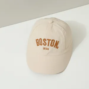 Close-up detail of BOSTON 1630 brown embroidery on light beige quick-dry baseball cap