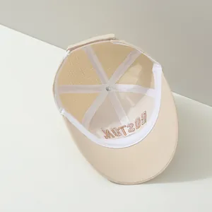 Detail view of internal seams and breathable laser-cut holes on beige kids baseball cap
