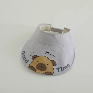 Detail of purple sun visor with cartoon capybara print and adjustable strap
