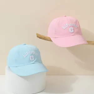Detail of pink and blue kids baseball caps featuring hi-baby embroidery and breathable mesh