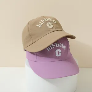 Detail of quick-dry kids baseball hats in khaki and purple with hi-baby embroidery