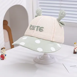 Detail of cute mint green sun hat with mesh fabric and 3D decorative ears for kids
