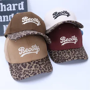 Detail view of cotton baseball caps with leopard print brims and Beooty 3D embroidery