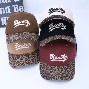 Detail view of multi-color baseball caps with leopard print brim and Beooty embroidery