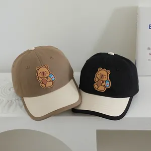 Kids baseball cap with cartoon bear patch and color-blocking design in khaki and black