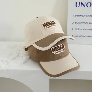 Detail of Hello Happiness 3D embroidery on beige and brown cotton kids baseball cap