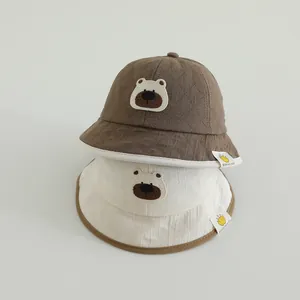 Close-up of baby sun hats featuring cute 3D bear embroidery and fine cotton texture